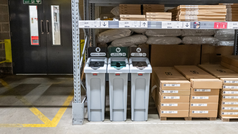 Three recycling bins labeled for general waste