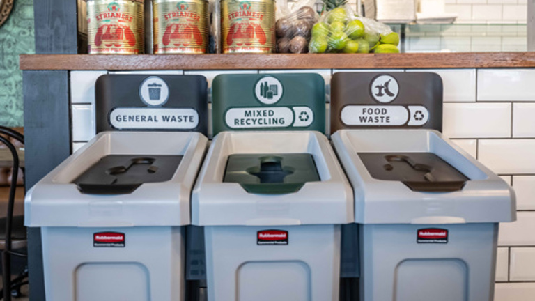 Three waste bins labeled for general waste