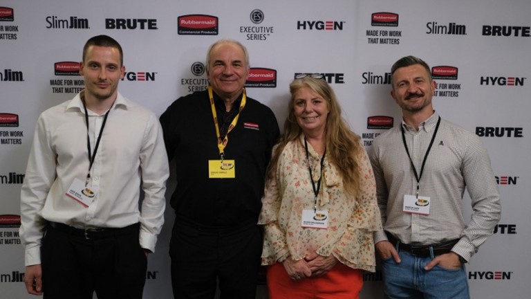 Four people smiling at a promotional event