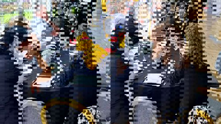 People sitting at a table in a cafe